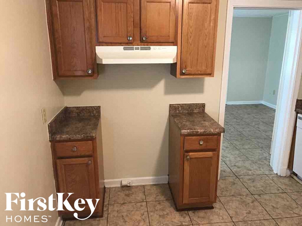 A kitchen with wooden cabinets and a countertop.