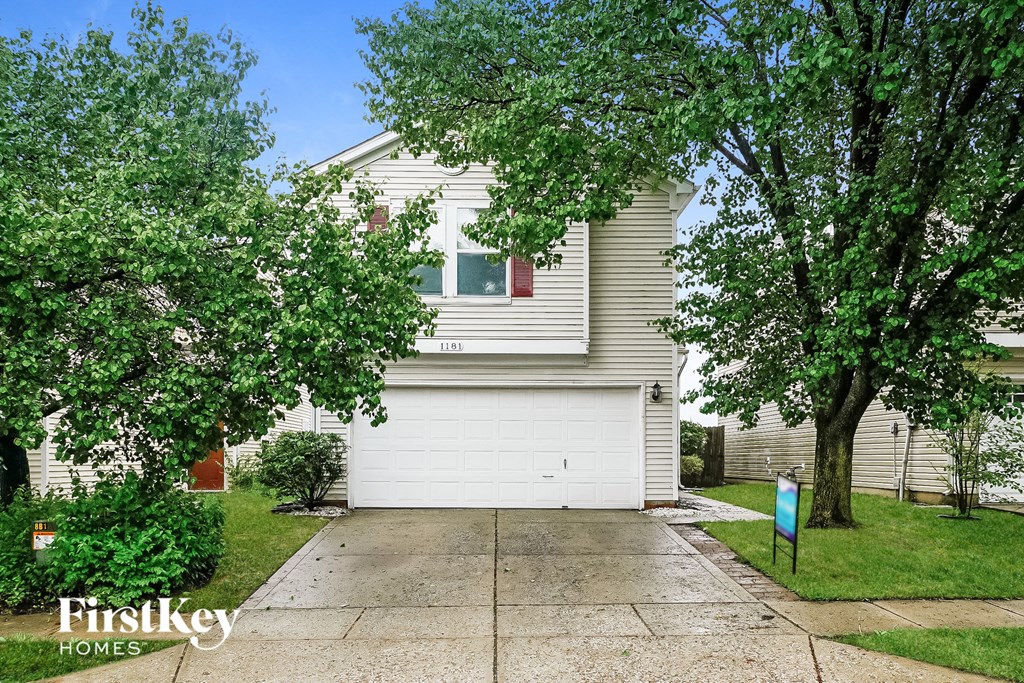 a white garage door in front of a white house