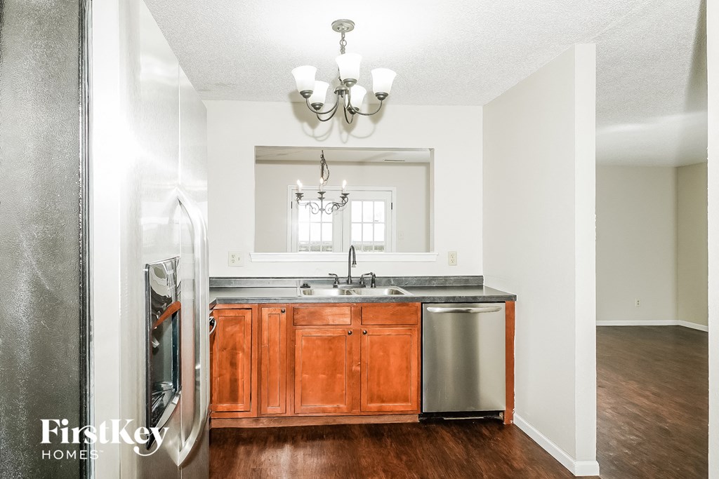 a kitchen with wooden cabinets and a sink and a refrigerator