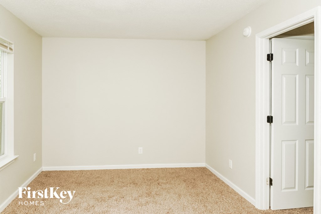 a empty room with a white wall and a white door