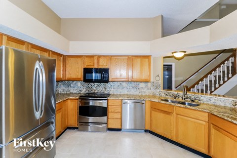 a kitchen with stainless steel appliances and wooden cabinets