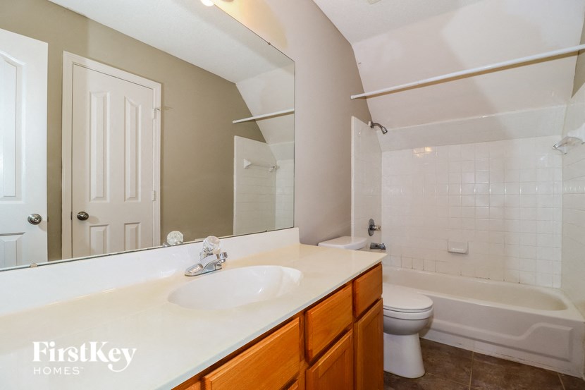 a full view of a bathroom with a sink and a toilet