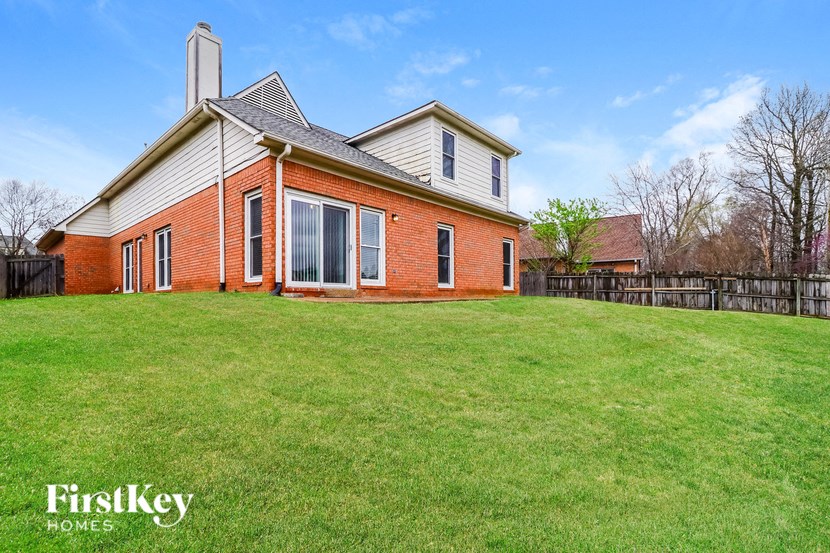 a brick house with a yard in front of it