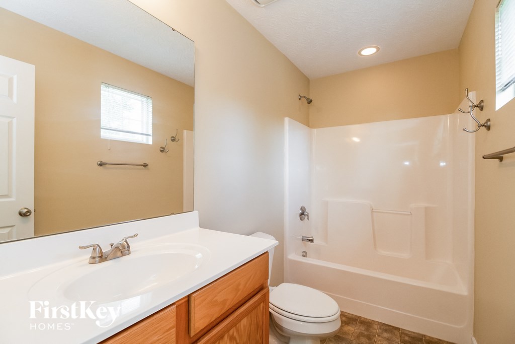 a bathroom with a sink and a shower and a toilet