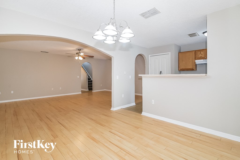 the living room and dining room with hardwood flooring