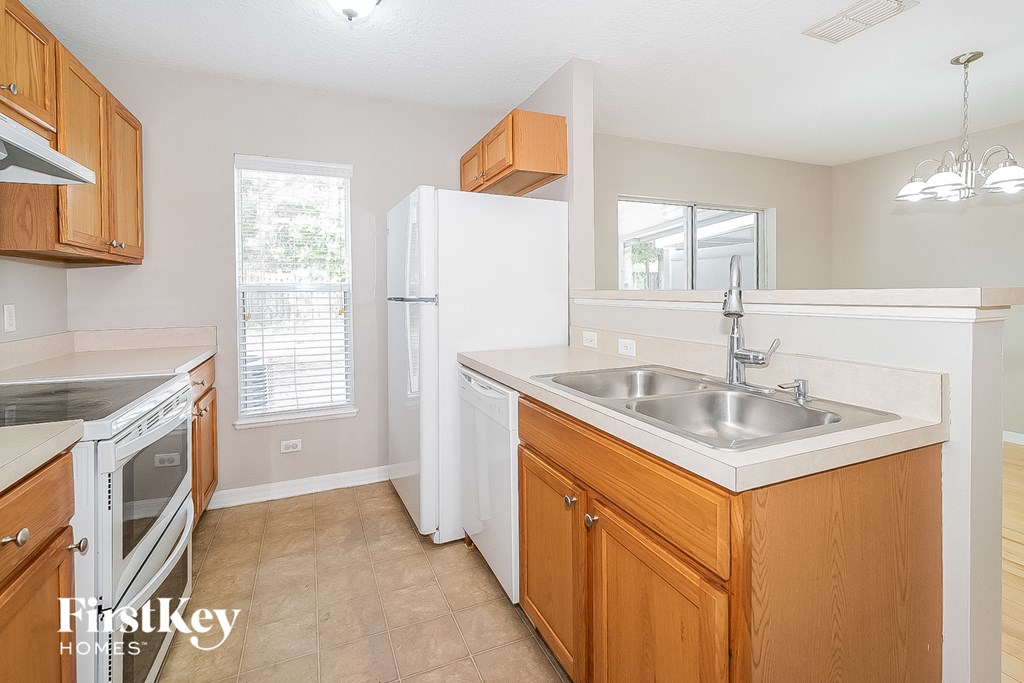 a kitchen with a sink and a stove and a refrigerator