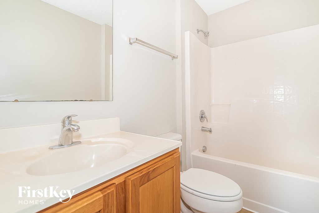 a bathroom with a sink and a toilet and a shower