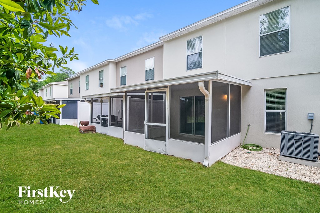a white house with a grass yard and a heater