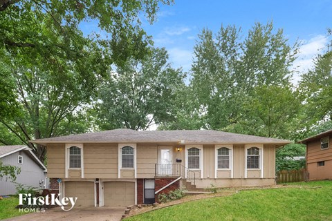 A house with a garage is for sale.