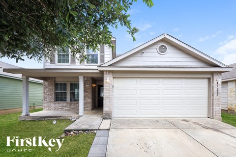 a white and brick house with a white garage door