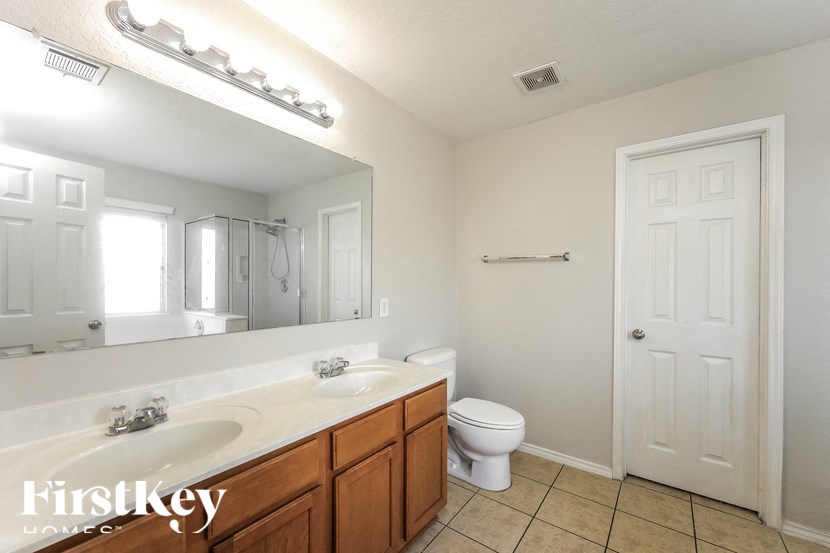 a bathroom with a toilet and a sink and a mirror