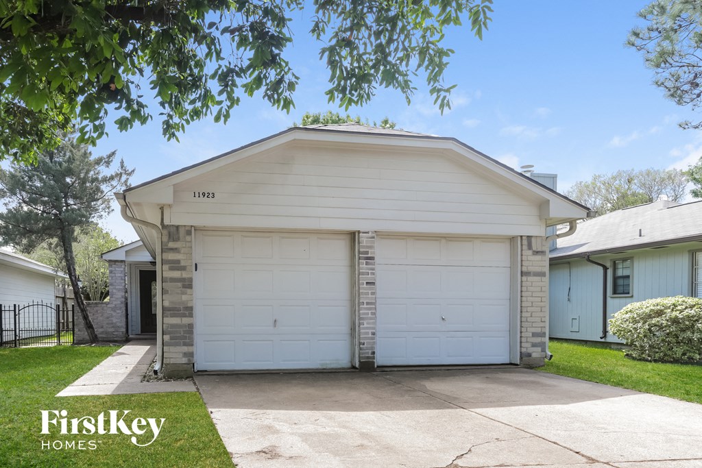 a white garage door in front of a white house