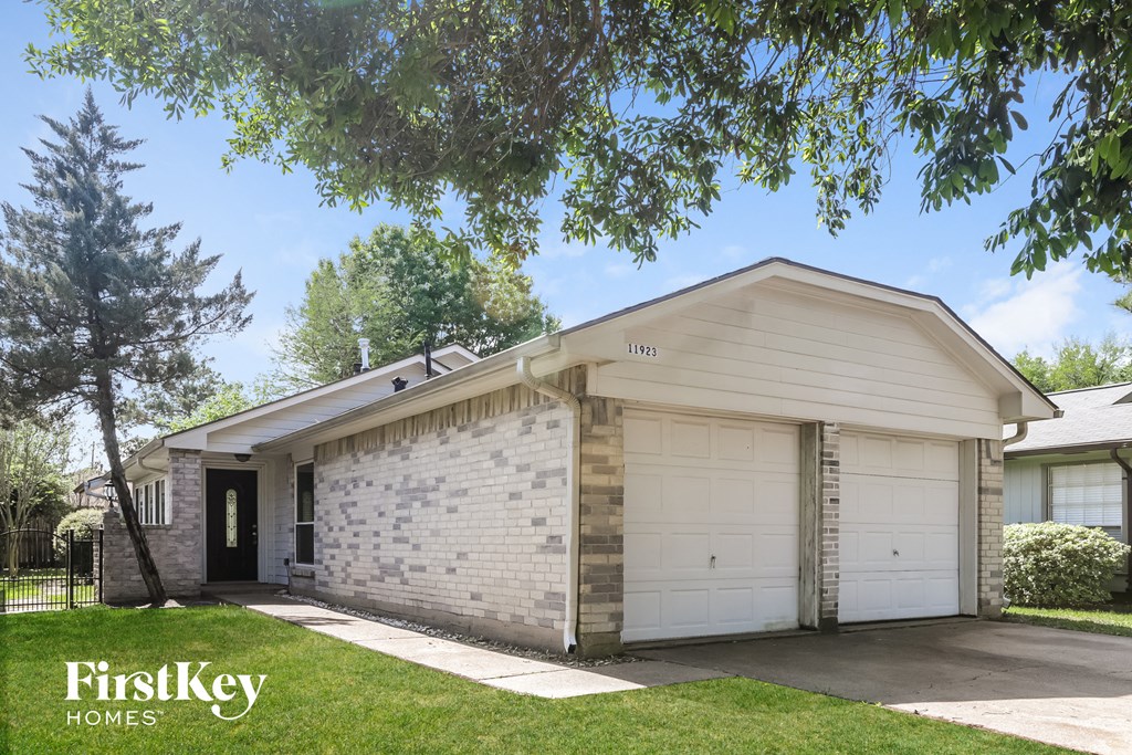 a white brick house with a white garage door