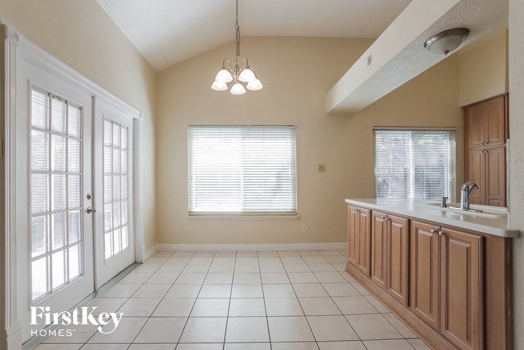 a kitchen with a sink and a window and a door