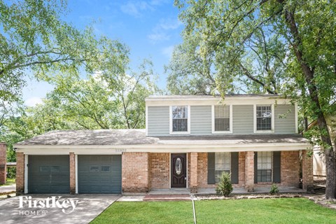 A two-story house with a garage on the first floor and a living area on the second floor.