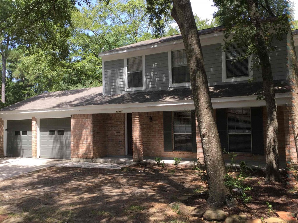 A house with a tree in front of it.