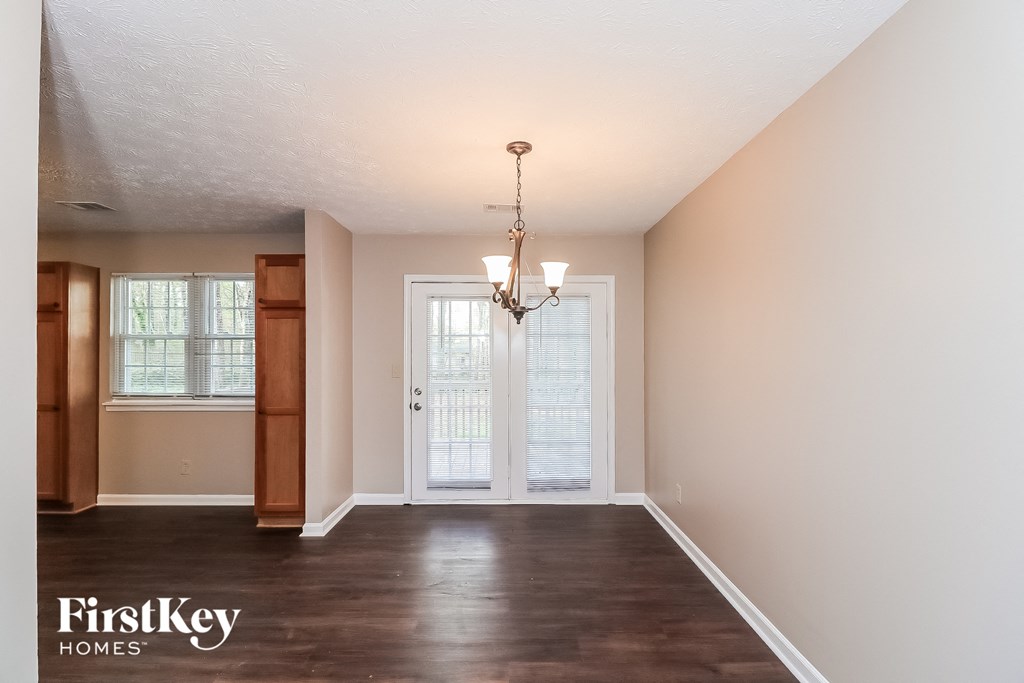 an empty living room with white walls and a white door