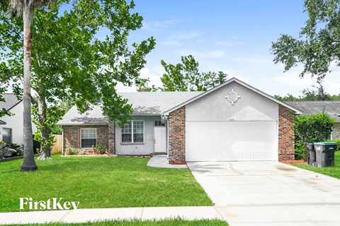 a white house with a yard and a white garage door