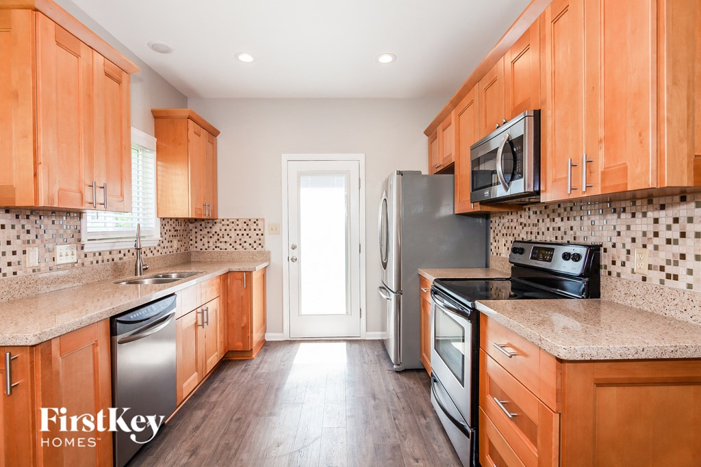 a kitchen with wooden cabinets and stainless steel appliances