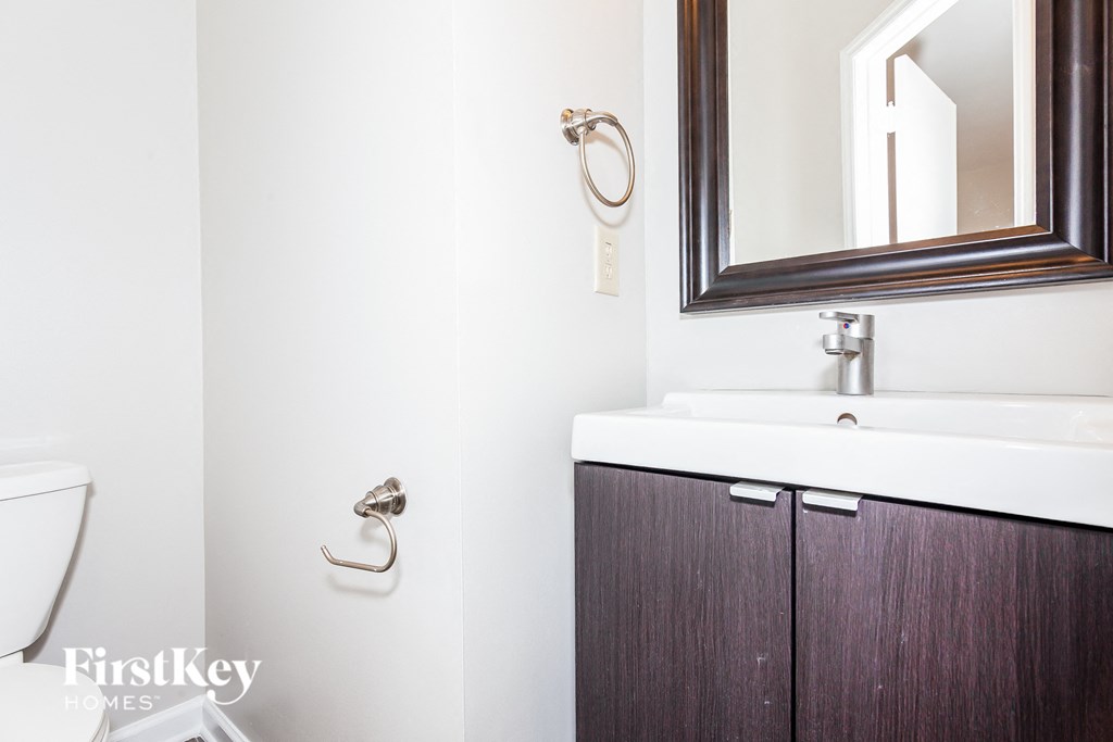a bathroom with a sink and a mirror and a toilet