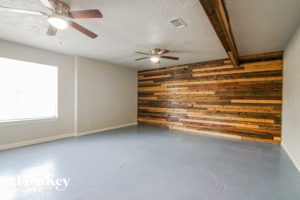 an empty room with a reclaimed wood wall