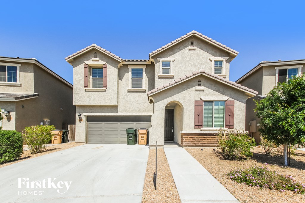A large house with a driveway in front of it.