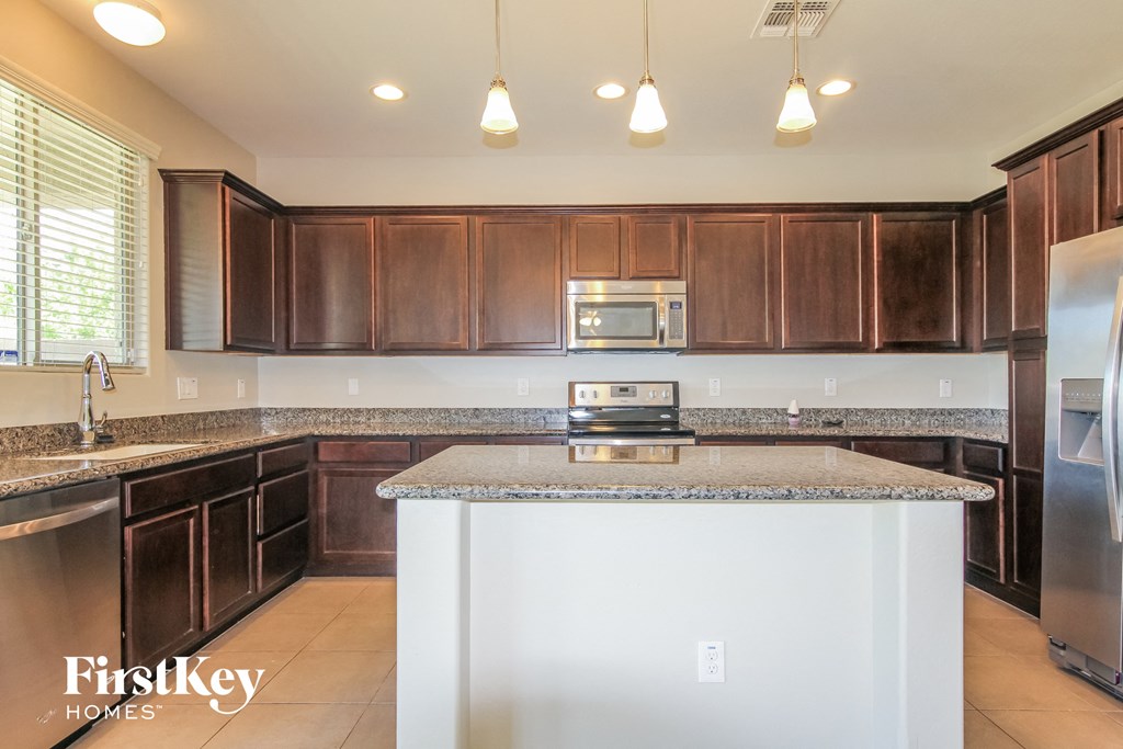A kitchen with brown cabinets and a white island.
