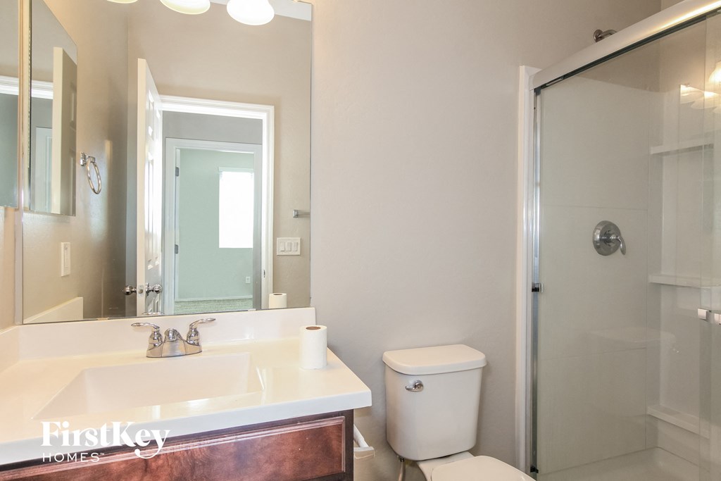 A white toilet sits next to a sink in a bathroom.