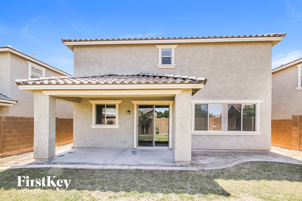 A house with a beige facade and a tiled roof is for sale.