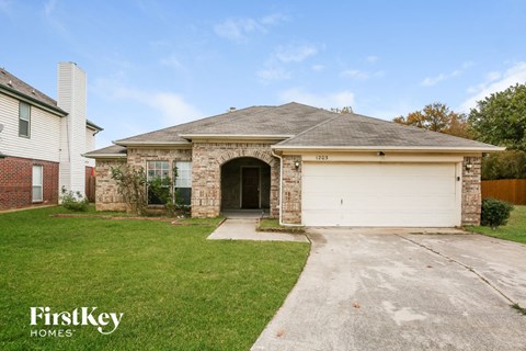 a brick house with a white garage door