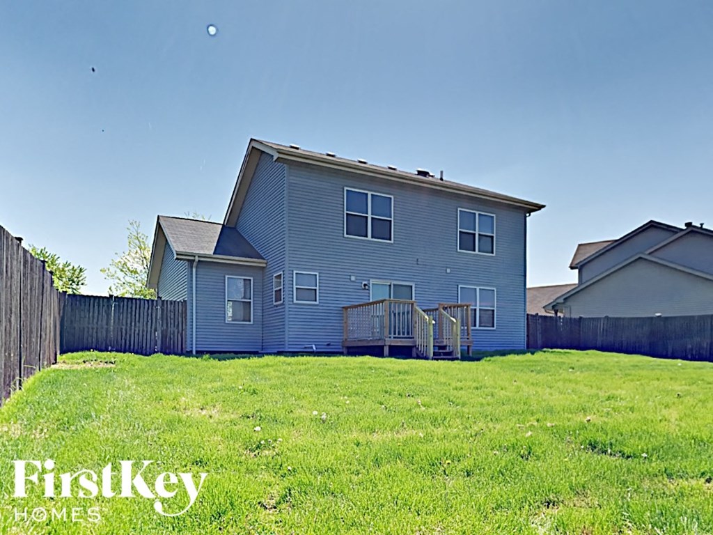 a blue house with a yard in front of it