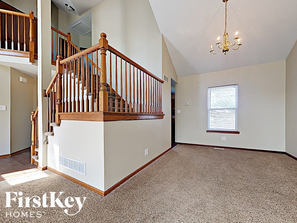 a fisheye view of a living room with a staircase and a landing