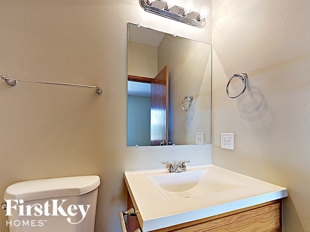 a bathroom with a sink and a toilet and a mirror