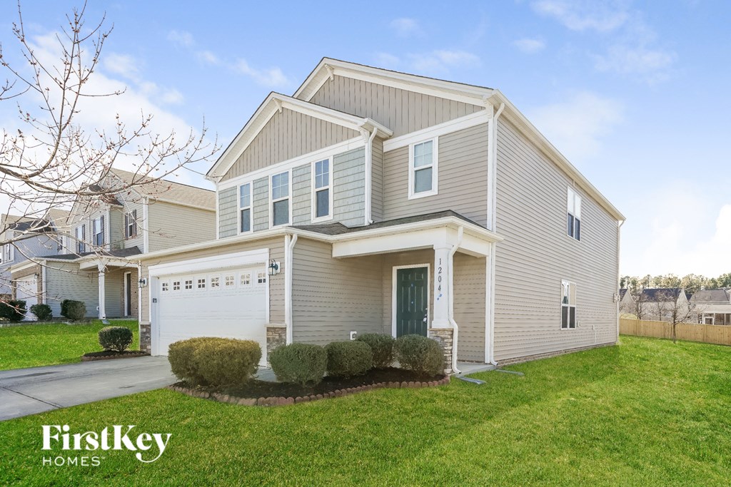 a beige and white house with a white garage door