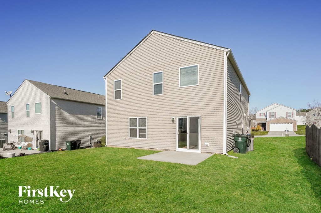 backyard and side view of a house with a yard and grass