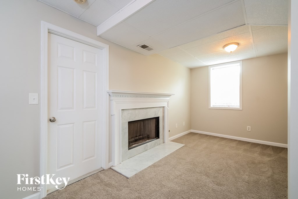 a living room with a fireplace and a white door