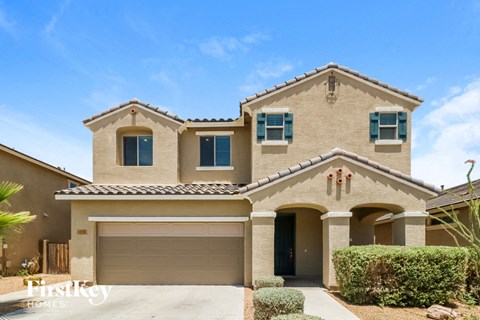 a house with a garage door in front of it
