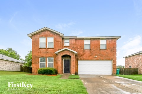 a brick house with a white garage door