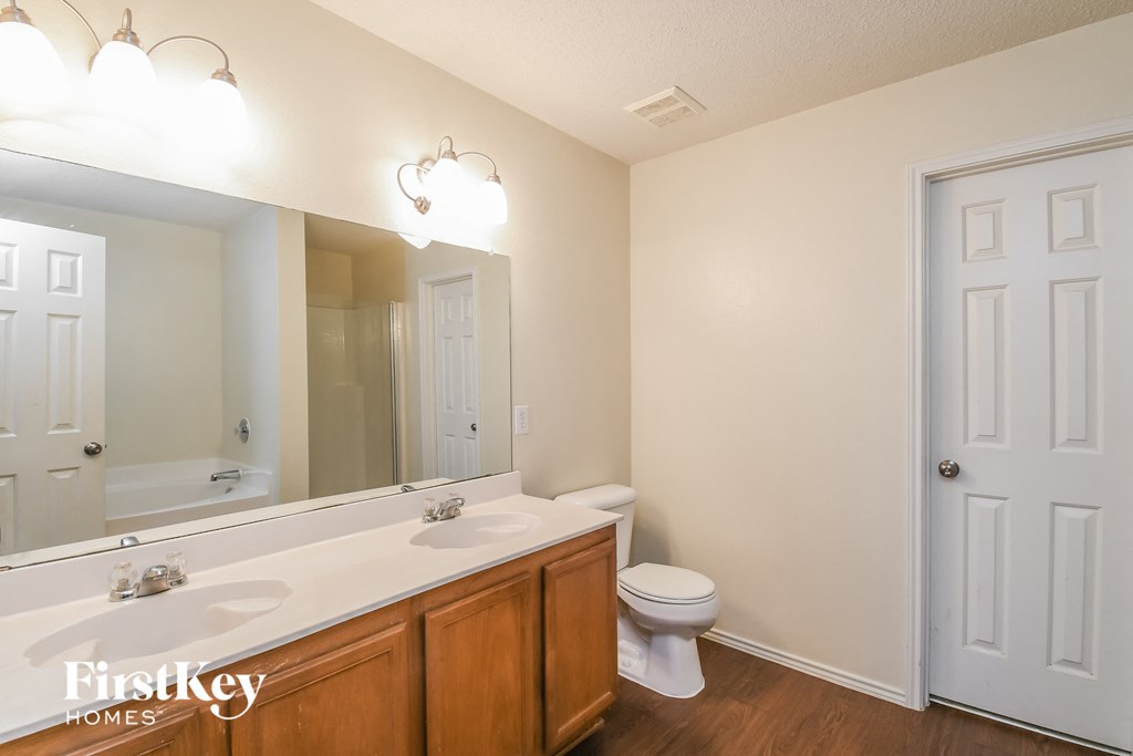 a bathroom with a toilet and a sink and a mirror