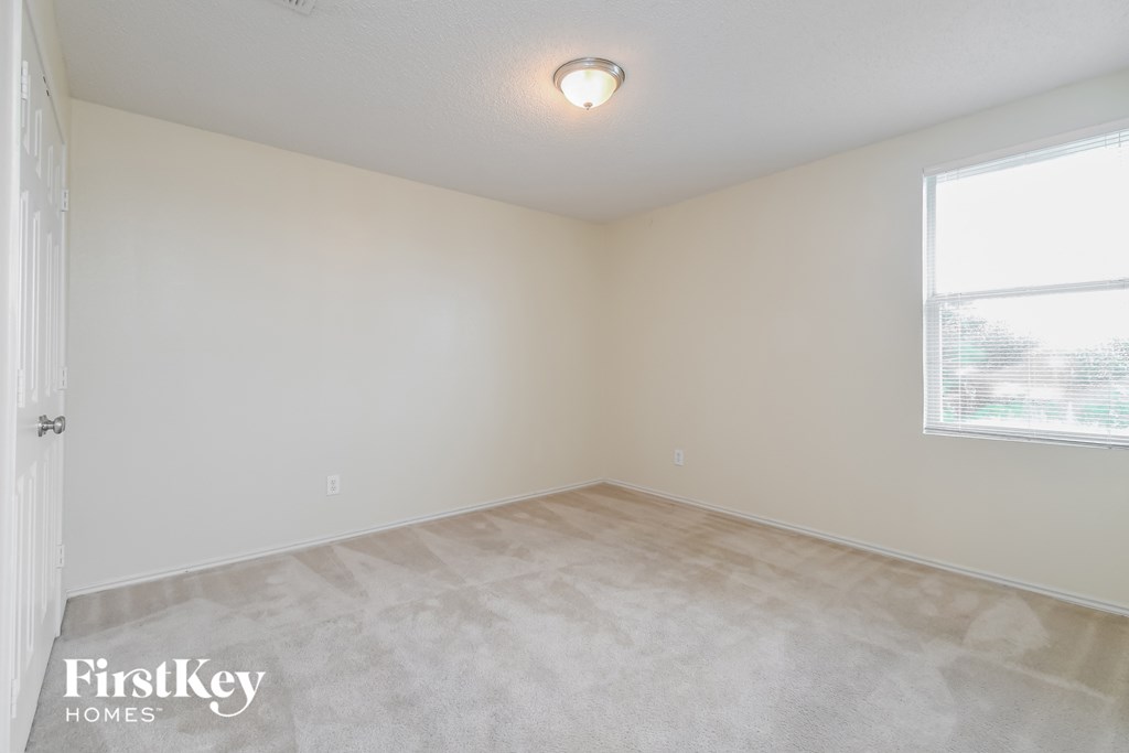the living room of an empty home with a large window