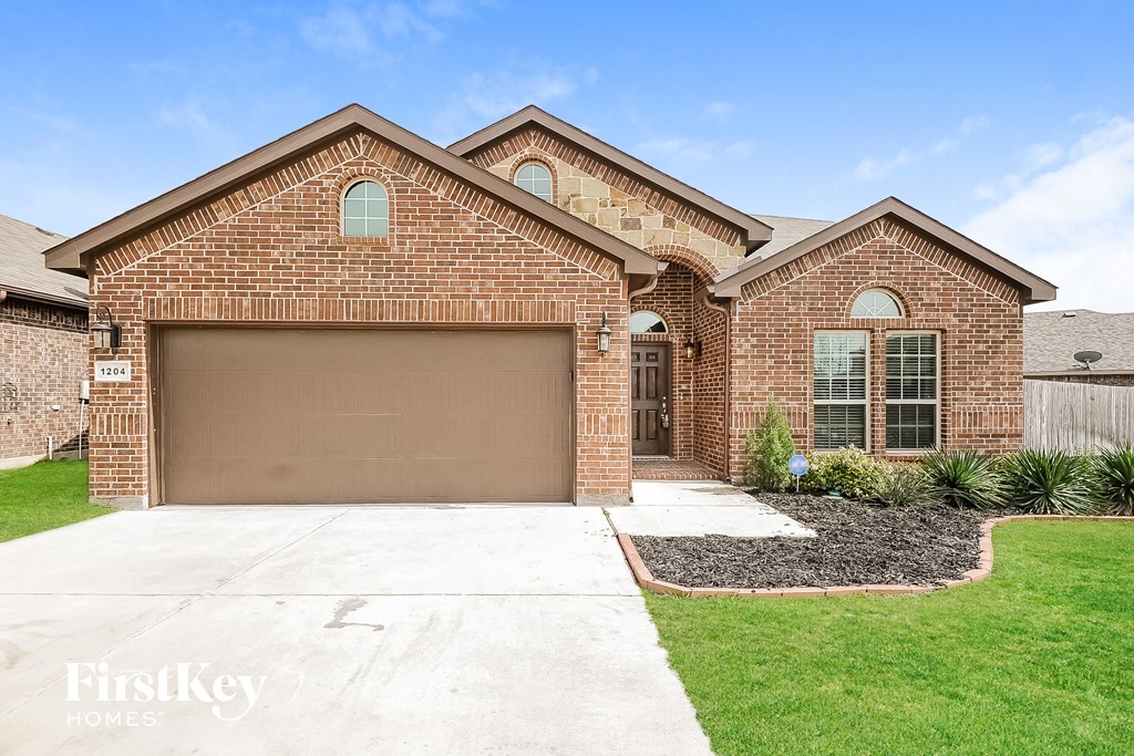 a brick home with a brown garage door