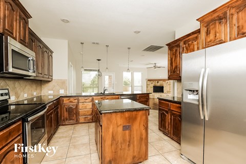 a kitchen with wooden cabinets and stainless steel appliances