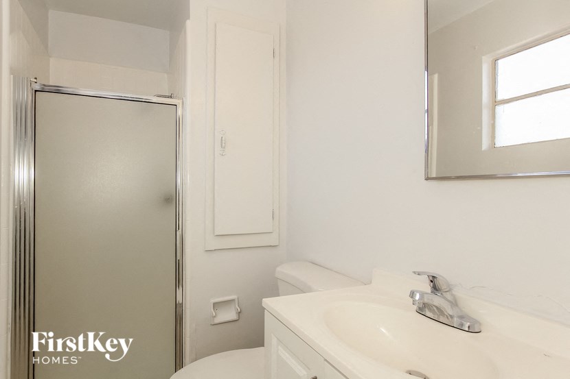 a bathroom with a sink toilet and a shower
