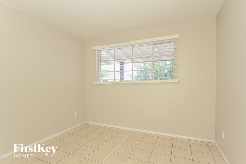 a empty room with a window and a tiled floor
