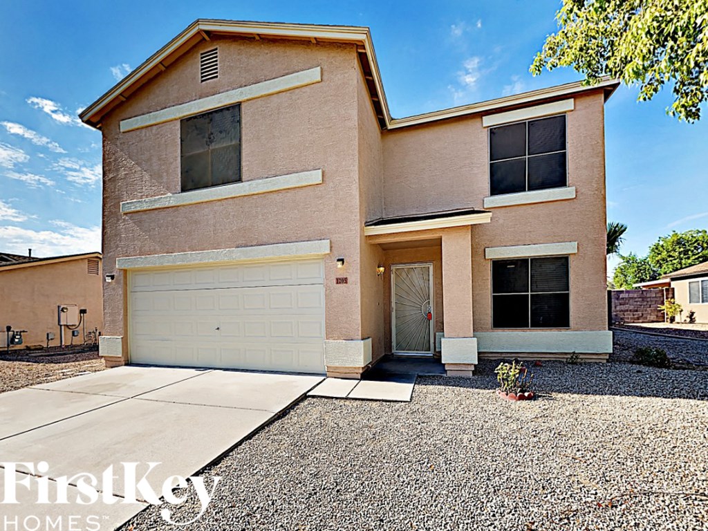 A two-story house with a garage is for sale.