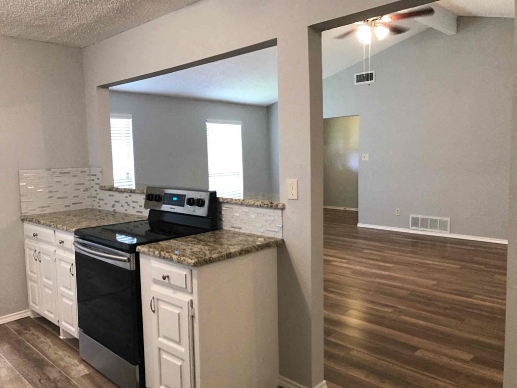 a kitchen with a stove and a large mirror