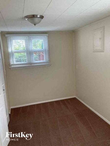 A room with a window and wooden flooring.
