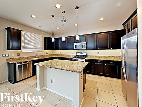 a kitchen with black cabinets and a counter top
