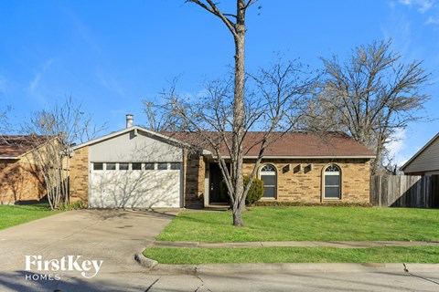 a brown brick house with a white garage door