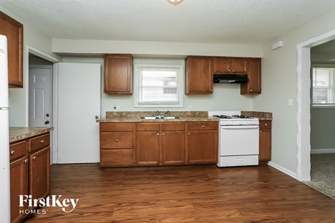 A kitchen with wooden cabinets and a white dishwasher.